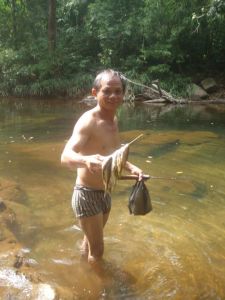 One of the porters fishing for some sustenance